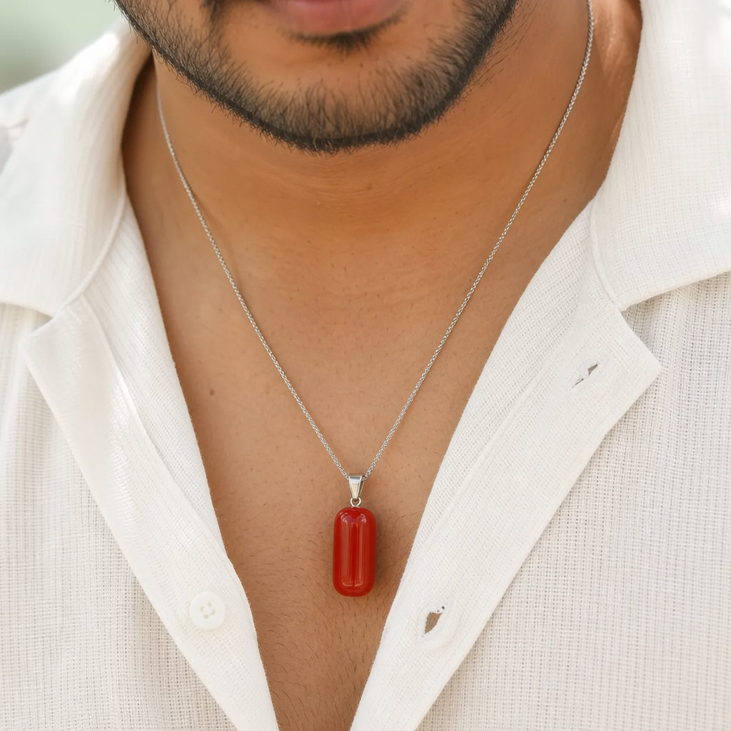 Moonga man wearing gemstone pendant