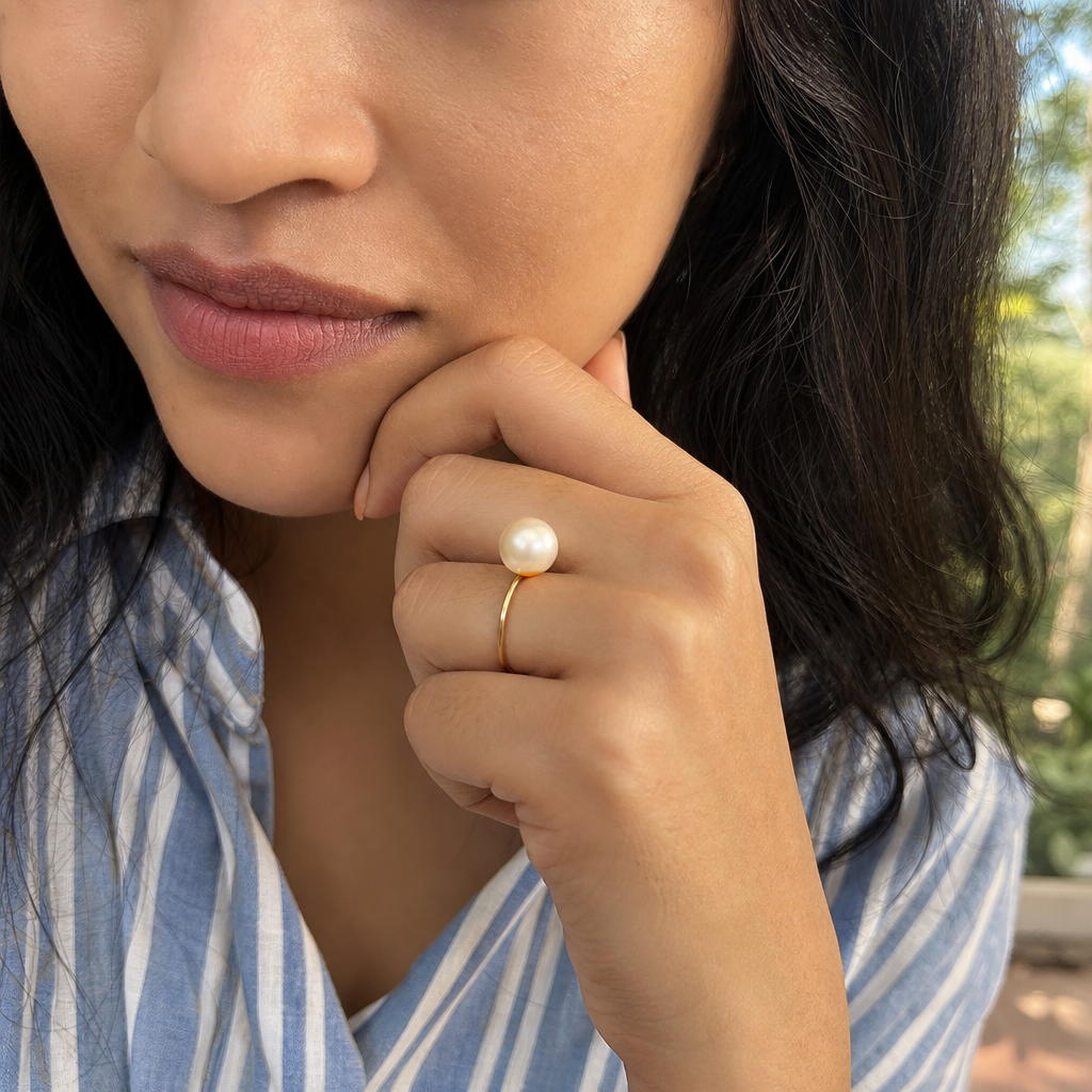 Pearl woman wearing gemstone ring