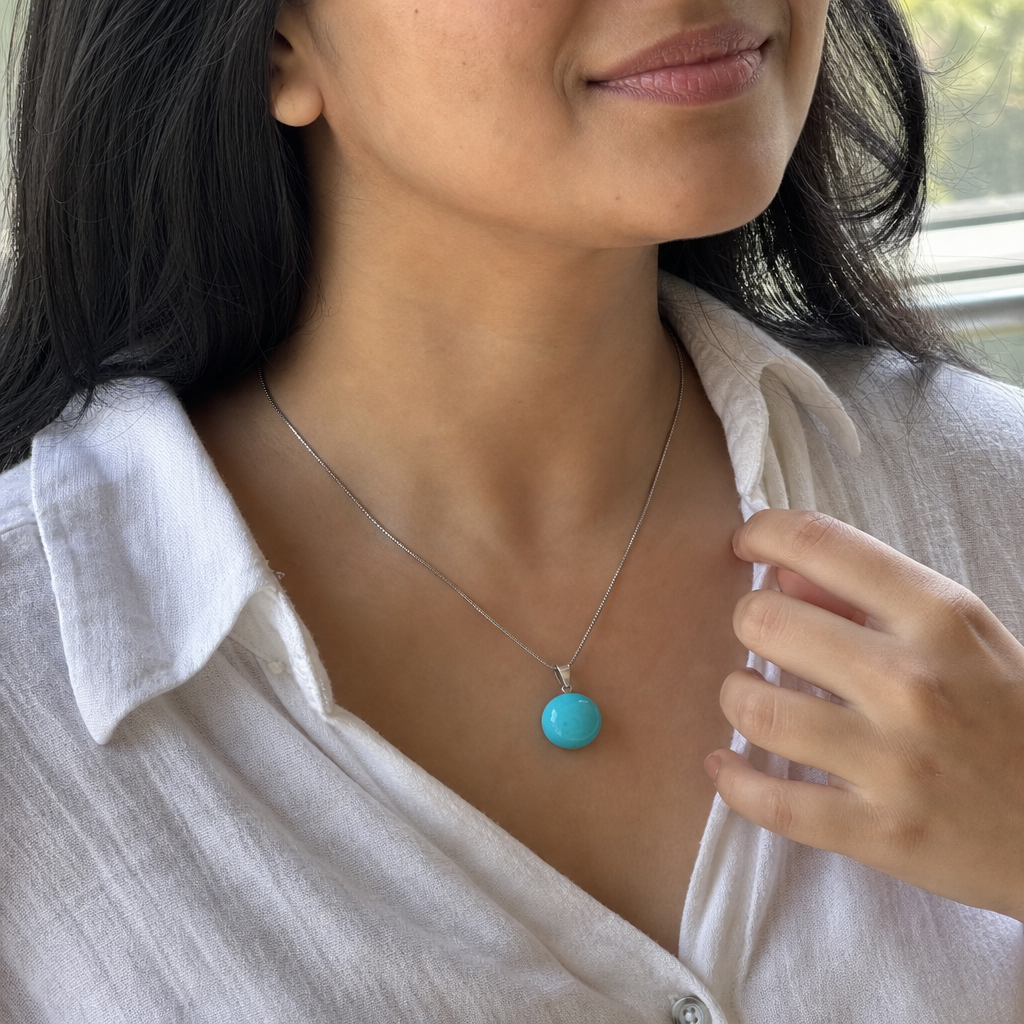 Turquoise woman wearing gemstone pendant